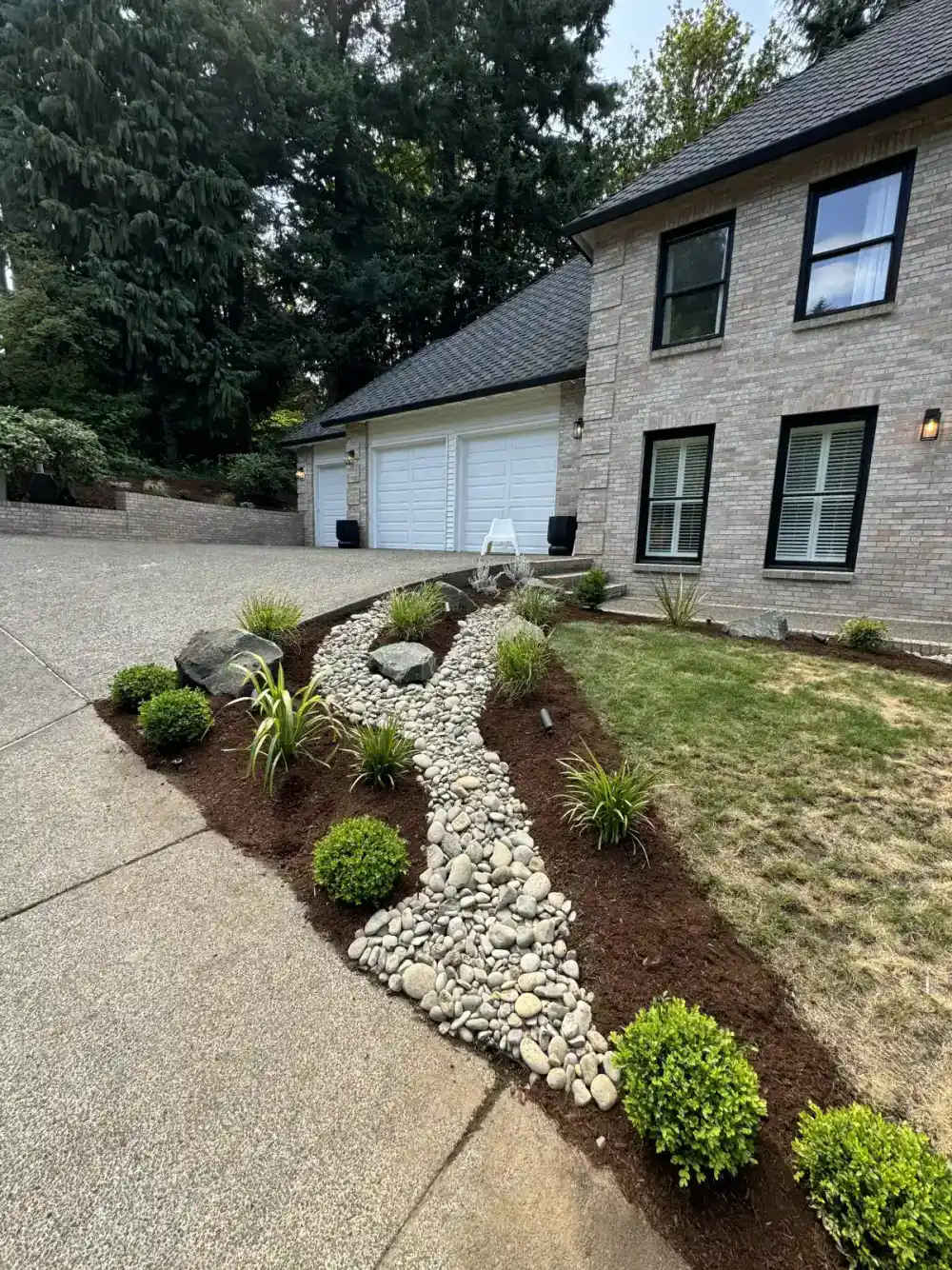 Fresh mulch installation around landscape beds by CreekView Landscape